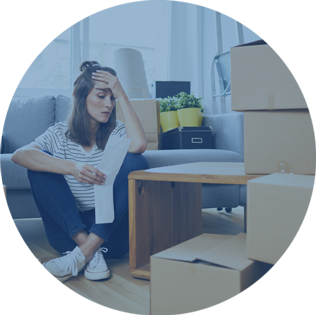 stressed woman sitting on floor with moving boxes